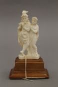 An early 20th century Indian ivory group, on stand. 13 cm high.