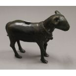 An archaistic style patinated bronze model of a ram. 17.5 cm long.