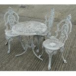 A round garden table and three metal garden chairs