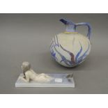 A Royal Copenhagen model of a mermaid and a pottery vase. The former 19.5 cm long.