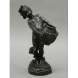 A patinated bronze casting of a putto water carrier, After A Moreau, unsigned. 23.5 cm high.