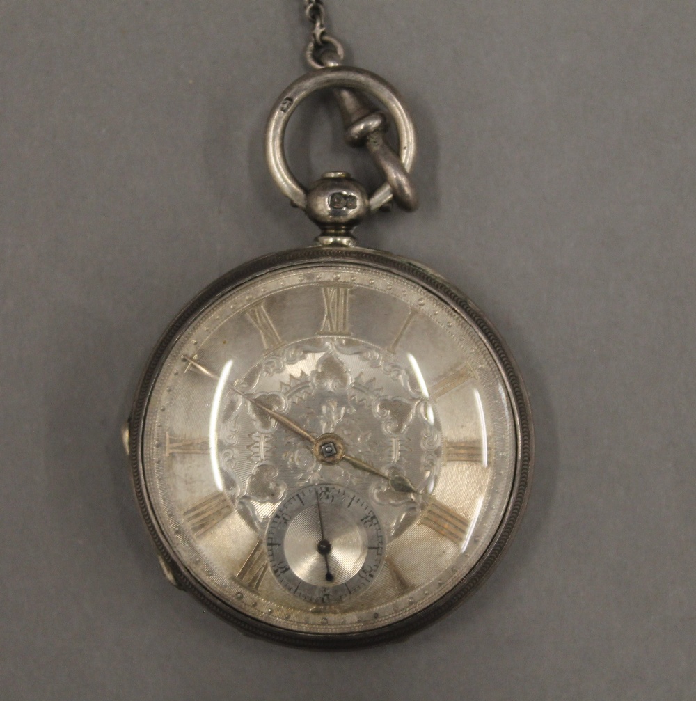 Two 19th century silver pocket watches on chains and a brass pocket watch case. - Image 10 of 12