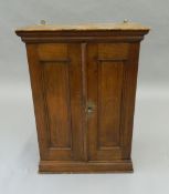 A Victorian oak wall hanging cupboard. 64.5 cm high.