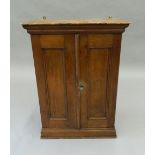 A Victorian oak wall hanging cupboard. 64.5 cm high.