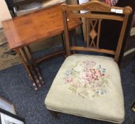 An Edwardian inlaid nursing chair with tapestry seat and original castors,