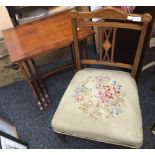 An Edwardian inlaid nursing chair with tapestry seat and original castors,