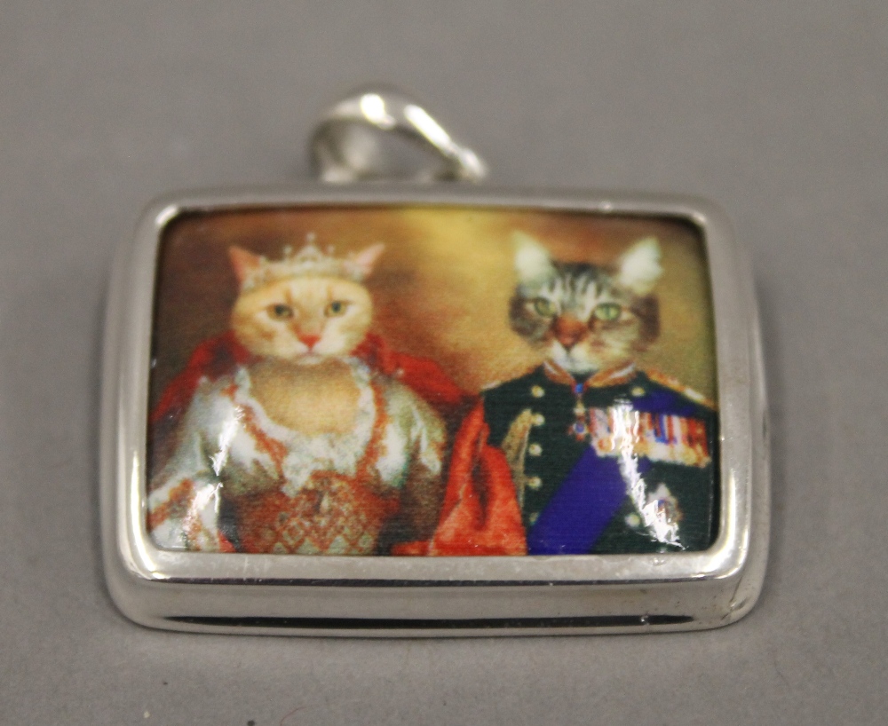 A silver enamel cat pendant. 3 cm wide.