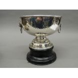 A large beaten silver punch bowl on stand. 23 cm diameter. 33.8 troy ounces of weighable silver.