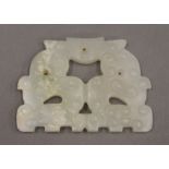 A white jade archaic style pendant. 6 cm wide.