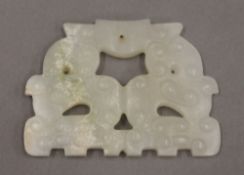 A white jade archaic style pendant. 6 cm wide.