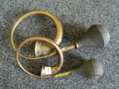 Two vintage car horns.