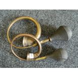 Two vintage car horns.