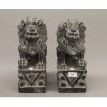 A pair of Chinese carved stone dogs-of-fo. 33 cm high.