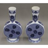 A pair of Minton blue and white porcelain vases. Each 25 cm high.