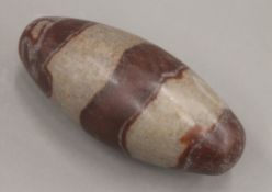 An Indian lingam stone. 14 cm long.