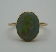 An unmarked gold and opal ring. Ring size P.