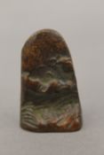 A small bronze seal decorated with a mountainous landscape. 4.5 cm high.