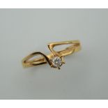 An 18 ct gold and diamond solitaire ring. Ring size M.