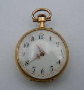 An 18 ct gold ladies fob watch. 2.5 cm diameter. 15.6 grammes total weight.