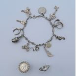 A silver charm bracelet and two silver rings. 33.1 grammes total weight.