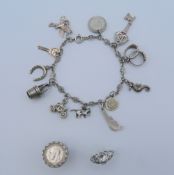 A silver charm bracelet and two silver rings. 33.1 grammes total weight.