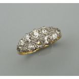 An 18 ct gold and platinum twelve stone diamond ring. Ring size P/Q.