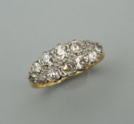 An 18 ct gold and platinum twelve stone diamond ring. Ring size P/Q.