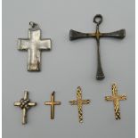 A quantity of cross formed pendants. The largest 6 cm high.