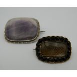A 19th century unmarked gold mourning brooch and an amethyst set silver brooch.