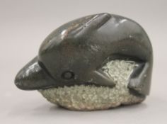 An Innuit carving on a dolphin. 12.5 cm long.