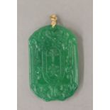 A gold topped apple green jade pendant. 6 cm high.