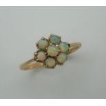 A 9 ct gold opal flowerhead ring. Ring size L.