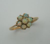 A 9 ct gold opal flowerhead ring. Ring size L.