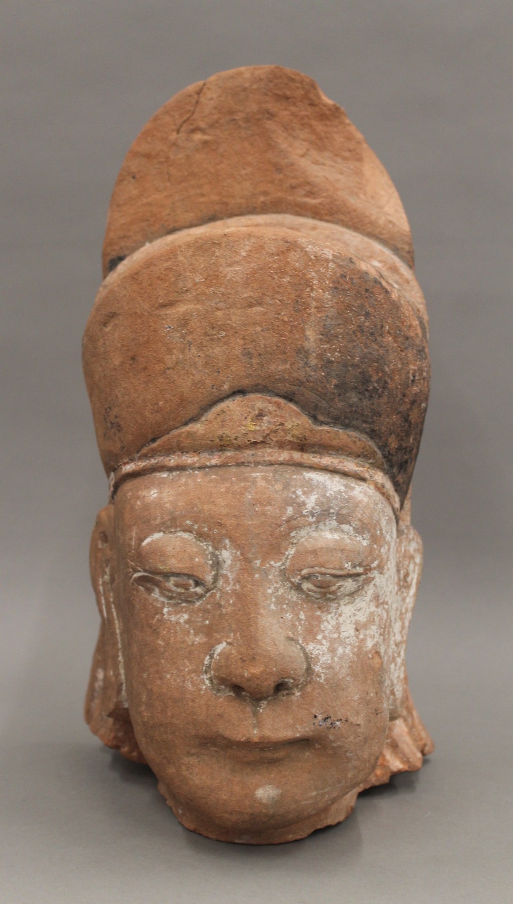 A Chinese carved stone head, possibly Ming. 35 cm high.