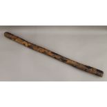 A carved Aboriginal didgeridoo. 100 cm long.