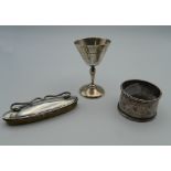 A silver napkin ring, a small silver cup and a nail buffer. 59.5 grammes of weighable silver.