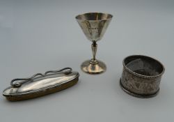 A silver napkin ring, a small silver cup and a nail buffer. 59.5 grammes of weighable silver.