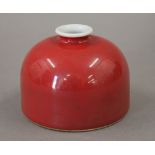 A Chinese red porcelain ink pot. 7.5 cm high.