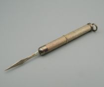 A silver cigar pricker. 7.5 cm long extended.