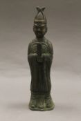 A Chinese bronze figure of an attendant. 24.5 cm high.