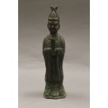A Chinese bronze figure of an attendant. 24.5 cm high.