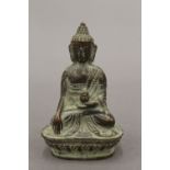 A small bronze model of Buddha. 7 cm high.