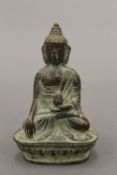 A small bronze model of Buddha. 7 cm high.