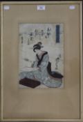 A Japanese woodblock print of a lady, framed and glazed. 21.5 x 31.5 cm.