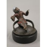 A cold painted bronze model of a smoking monkey, on stand. 6.5 cm high.