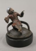 A cold painted bronze model of a smoking monkey, on stand. 6.5 cm high.