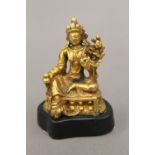 A miniature gilt bronze model of Buddha, mounted on a stand. 5.25 cm high.