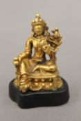 A miniature gilt bronze model of Buddha, mounted on a stand. 5.25 cm high.