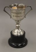 A small silver trophy cup, on stand. 16.5 cm high. 80.7 grammes of weighable silver.