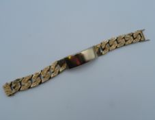 A gold plated identity bracelet. 20 cm long. 119.3 grammes.